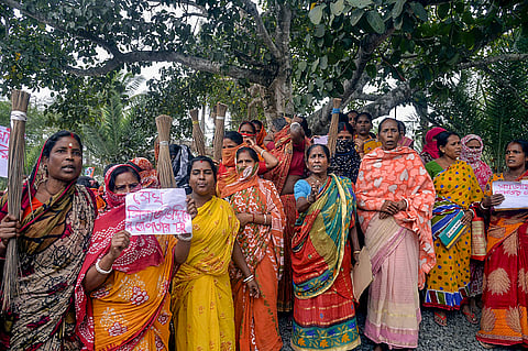 Women holding posters stage a protest demanding the arrest of local TMC leaders over Sandeshkhali incident allegations, in North 24 Parganas district, Sunday, Feb. 25, 2024.