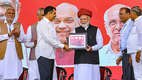 Prime Minister Narendra Modi being felicitated during the golden jubilee celebration of Gujarat Cooperative Milk Marketing Federation (GCMMF), in Ahmedabad, Thursday, Feb. 22, 2024. Gujarat Governor Acharya Devvrat and Union Minister Parshottam Rupala are also seen.