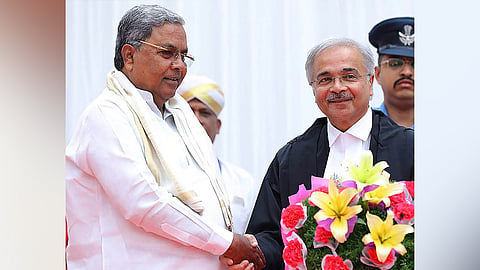 Chief Minister Siddaramaiah congratulates Justice Nilay Vipinchandra Anjaria at Raj Bhavan on Sunday.