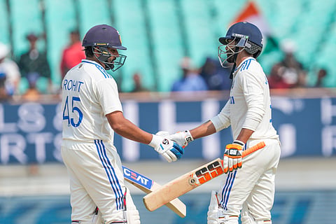 Rohit Sharma, left greets Ravindra Jadeja after he scored fifty runs on the first day of the third cricket test match between India and England in Rajkot, India, Thursday, Feb. 15, 2024.