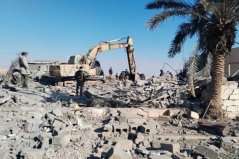 Members of Iraqi Shiite Popular Mobilization Forces clean the rubble after a U.S. airstrike in al-Qaim, Iraq, Saturday, Feb. 3, 2024.