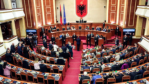 Lawmakers of the Democratic Party, left, look on as their colleagues of the ruling Socialist party vote in Tirana, Albania, Thursday, Feb. 22, 2024.