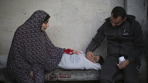 Palestinians mourn a child killed in Israeli bombardment of the Gaza Strip at a hospital morgue in Rafah, Monday, Feb 12, 2024.
