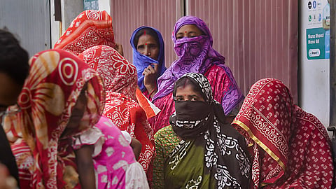 Local women wait to meet National Commission for Women (NCW) representative at Sandeshkhali, in North 24 Parganas district, Monday, Feb. 19, 2024.