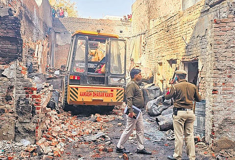 Police at the paint factory where a massive fire broke out on Wednesday at Alipur