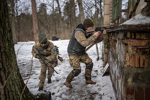People practice combat skills in urban areas during a training course for the national resistance of the Municipal Guard near Kyiv, Ukraine.