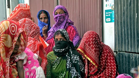 Local women wait to meet the National Commission for Women (NCW) representative at Sandeshkhali.