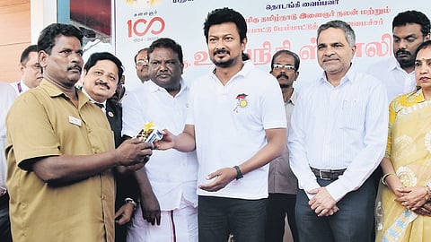 Udhayanidhi Stalin distributing electronic ticketing machines to conductors in the presence of Transport Minister S S Sivasankar at a function in Guindy