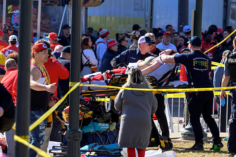 A woman is taken to an ambulance after an incident following the Kansas City Chiefs NFL football Super Bowl celebration in Kansas City, Mo., Wednesday, Feb. 14, 2024. The Chiefs defeated the San Francisco 49ers Sunday in the Super Bowl 58.