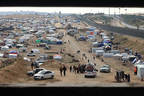 Displaced Palestinians camp near the border fence between Gaza and Egypt