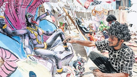 Artists painting the Mayana Kollai idols in Vellore district