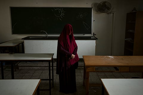 Nabela, who was detained by Israeli forces, poses for a portrait at the U.N. school where she is sheltering in Rafah, southern Gaza Strip.