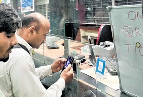 A person buys a ticket through UPI at KSR Railway Station