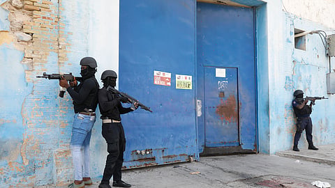 National Police stand guard outside the empty National Penitentiary after a small fire inside in downtown Port-au-Prince, Haiti, Haiti.