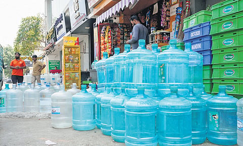 Empty water cans kept outside a shop near Domlur, as the water problem grows in Bengaluru on Sunday.