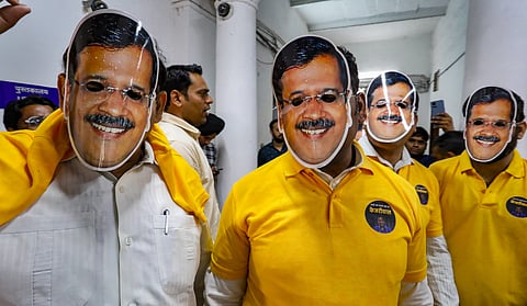AAP MLAs wear masks of Chief Minister Arvind Kejriwal during their protest against CM's arrest, at the Delhi Legislative Assembly, in New Delhi, Wednesday, March 27, 2024.