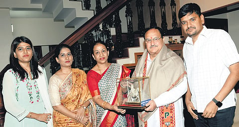 BJP national president JP Nadda is welcomed by party MP Mangala Suresh Angadi, as Shraddha Shettar, her husband Sankalp Shettar, and Spoorthi Patil, look on, at the Angadi residence in Belagavi on Wednesday