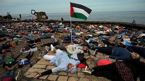 Pro-Palestinian demonstrators lie on the ground as they protest against Israeli attacks on Gaza, in San Sebastian, northern Spain.