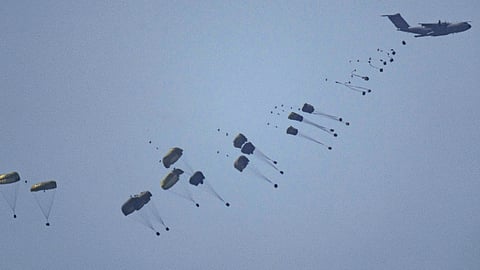 An aircraft airdrops humanitarian aid over Gaza the northern Gaza Strip, as seen from southern Israel, Friday, March 8, 2024.