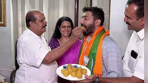 P C George offers sweets to BJP’s Pathanamthitta candidate Anil K Antony at his residence in Poonjar on Monday.