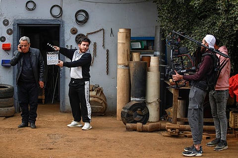 Iraqi actors film scenes of a television series to be broadcast during the Muslim holy month of Ramadan on February 23, 2024, in the Sheikh Omar neighbourhood in Baghdad.