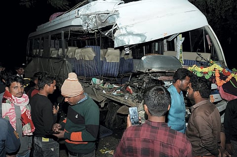 Locals at the site after a collision of a bus with a truck, in Lohardaga district, Jharkhand.