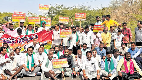 Farmers stage a protest demanding the release of water into the Flood Flow Canal for irrigation in Karimnagar district on Sunday