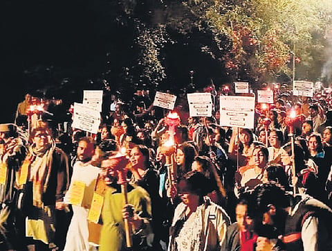 Students carrying torches march from Jhelum Lawns to Ganga Dhaba