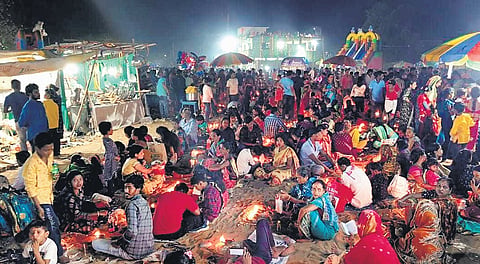 Devotees light diyas outside Lokanath temple in Puri on Friday