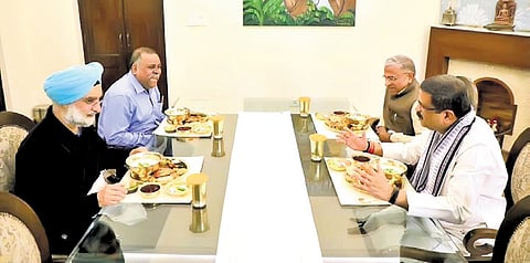 Union Minister Dharmendra Pradhan enjoying Pakhala with Rajya Sabha deputy chairperson Harivansh and former diplomat Taranjit Singh Sandhu