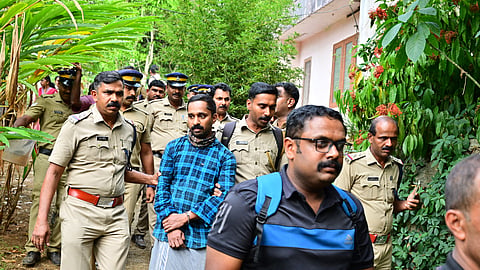 Police officers coming out with the accused Nitheesh from the Kakkattukada house, where Vijayan was murdered and buried.