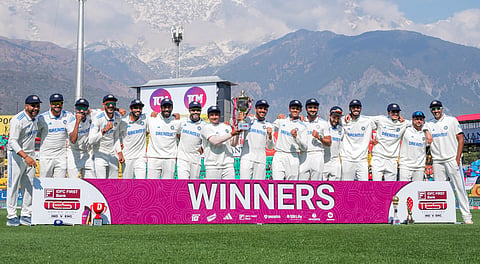 Indian players pose for photos with the trohpy after winning the fifth Test cricket match over England, in Dharamsala, Saturday, March 9, 2024. India won the five-match series 4-1.
