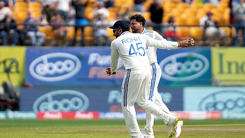Kuldeep Yadav celebrates the wicket of Ollie Pope with captain Rohit Sharma