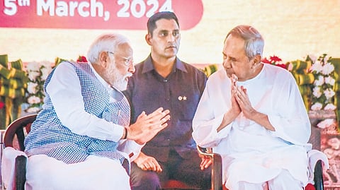 Prime Minister Narendra Modi has a word with Chief Minister Naveen Patnaik during an official function in Chandikhole, on Tuesday