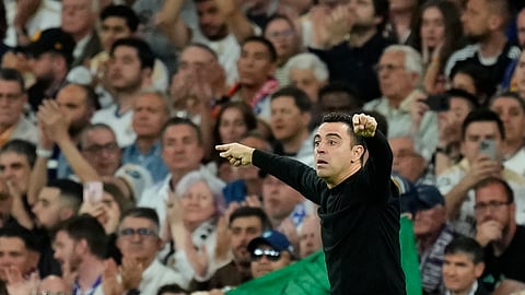 Barcelona's head coach Xavi Hernandez gestures during the Spanish La Liga soccer match between Real Madrid and Barcelona at the Santiago Bernabeu stadium in Madrid, Spain, Sunday, April 21, 2024.