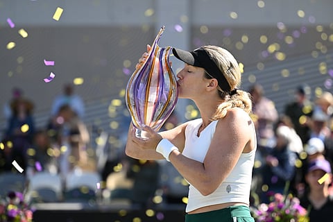 Collins kisses the Charleston Open trophy after defeating 11th-ranked Daria Kasatkina.