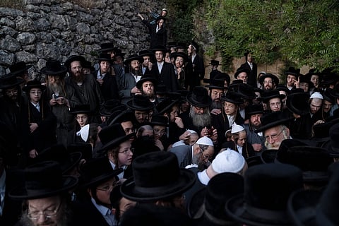 Ultra-Orthodox Jewish men collect water from a spring to make matzoh, a traditional handmade unleavened bread for the holiday of Passover.