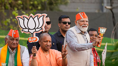 Prime Minister Narendra Modi with Uttar Pradesh Chief Minister Yogi Adityanath and Union Minister of State V.K. Singh during a road show, ahead of Lok Sabha elections, in Ghaziabad.