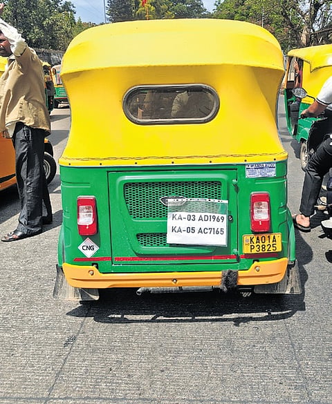 An autorickshaw plying in Bengaluru displaying multiple registration numbers