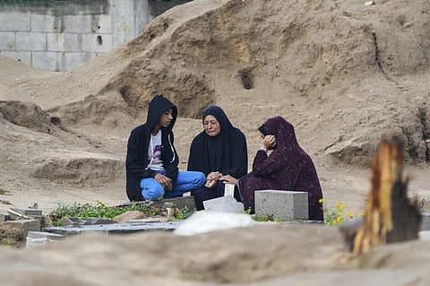Palestinians visit the graves of their relatives who were killed in the war between Israel and the Hamas militant group on the first day of the Muslim holiday of Eid al-Fitr, in Deir al-Balah, Gaza, Wednesday, April 10, 2024.
