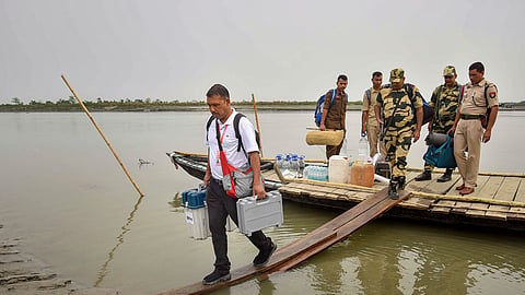 Polling officials and security personnel with EVMs and other election materials disembark from a ferry on their way to a polling station ahead of the first phase of Lok Sabha elections, in Golaghat, Assam, Thursday, April 18, 2024.