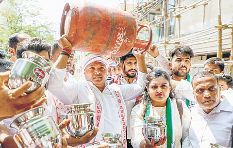 Indian Youth Congress president BV Srinivas and supporters arrive at a polling booth to cast their votes, in Bengaluru on Friday