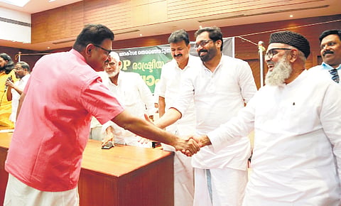 PDP vice-chairman Mohammed Bilal and (L) Kochi Mayor M Anilkumar shake hands at the party’s central committee meeting on Friday.