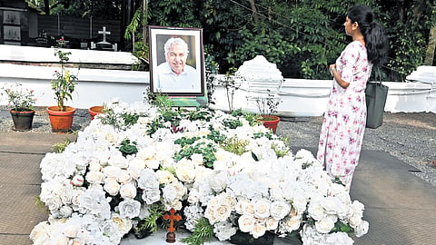 A youngster prays at the grave of former chief minister Oommen Chandy at the Puthuppally Church