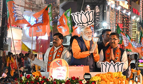 Prime Minister Narendra Modi with Madhya Pradesh Chief Minister Mohan Yadav and BJP candidate Ashish Dubey during a road show ahead of Lok Sabha elections, in Jabalpur, Sunday, April 7, 2024.