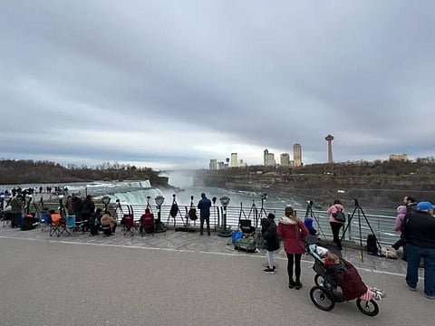 Spectators gather at the world-famous Niagara Falls under cloudy skies. (AP Photo)