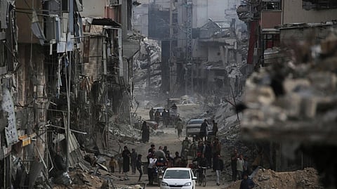 Palestinians walk back into the devastated remains of Khan Yunis in Gaza after the Israeli army withdrew.