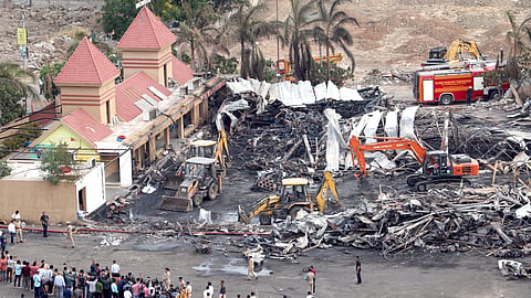 Debris being removed from the game zone site where a major fire on Saturday evening killed at least 27 people and injured three, in Rajkot