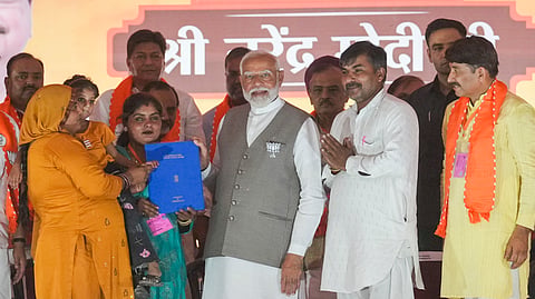 PM Narendra Modi with party candidate Manoj Tiwari during a rally for Lok Sabha elections, at Kartar Nagar in New Delhi on Saturday.