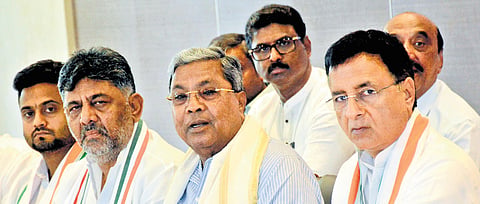 Chief Minister Siddaramaiah, flanked by Deputy Chief Minister DK Shivakumar and AICC general secretary Randeep Singh Surjewala, addresses a press conference in Belagavi on Sunday
